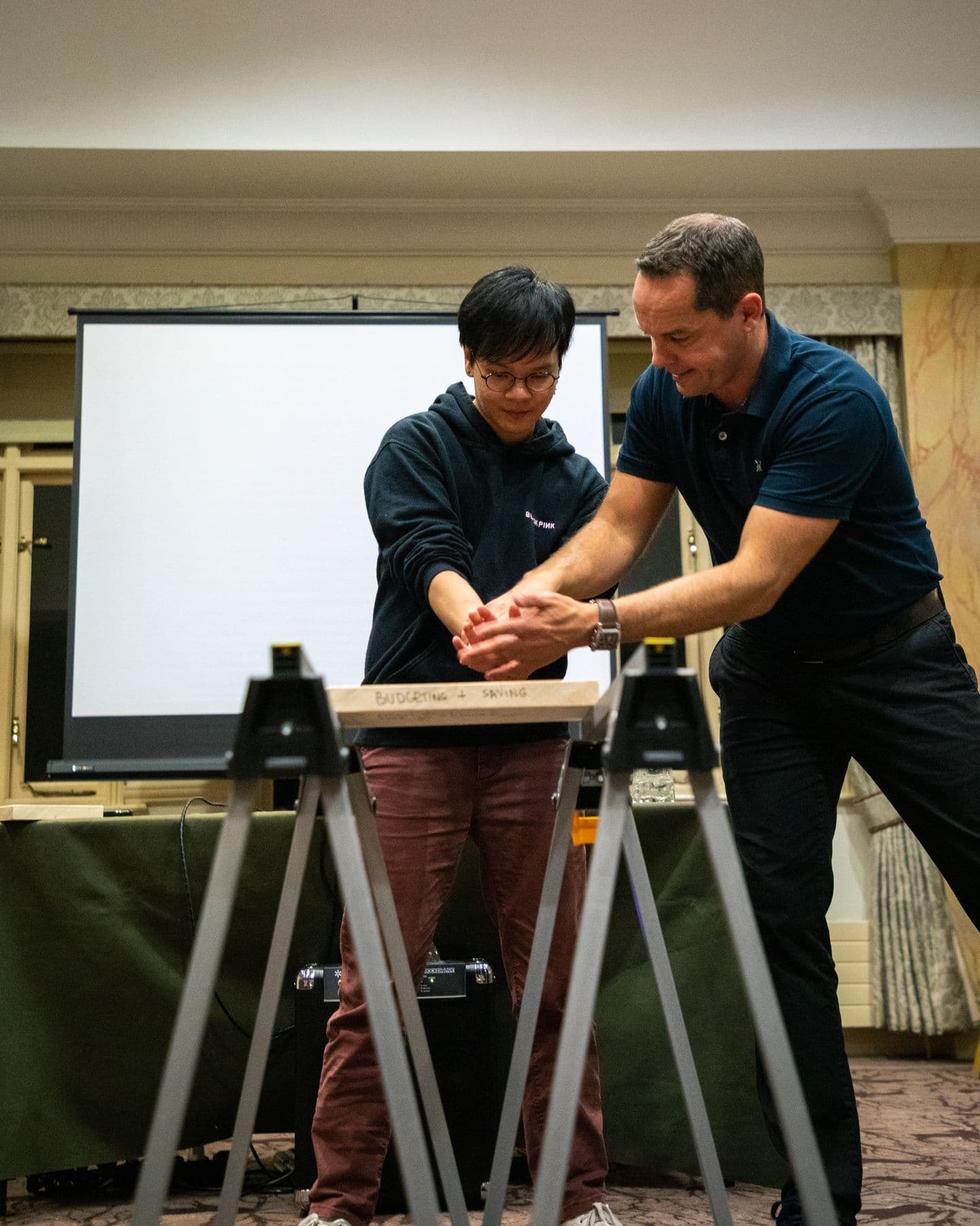 An instructor coaching a participant through a board break