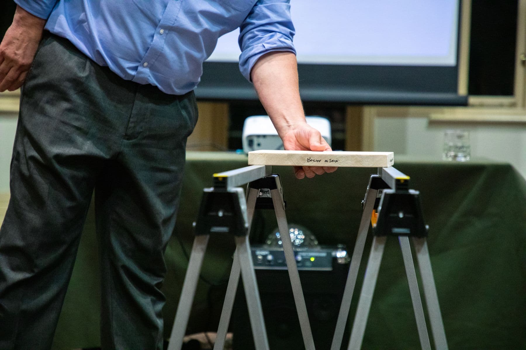 A hand resting on a wooden board, ready for a board break