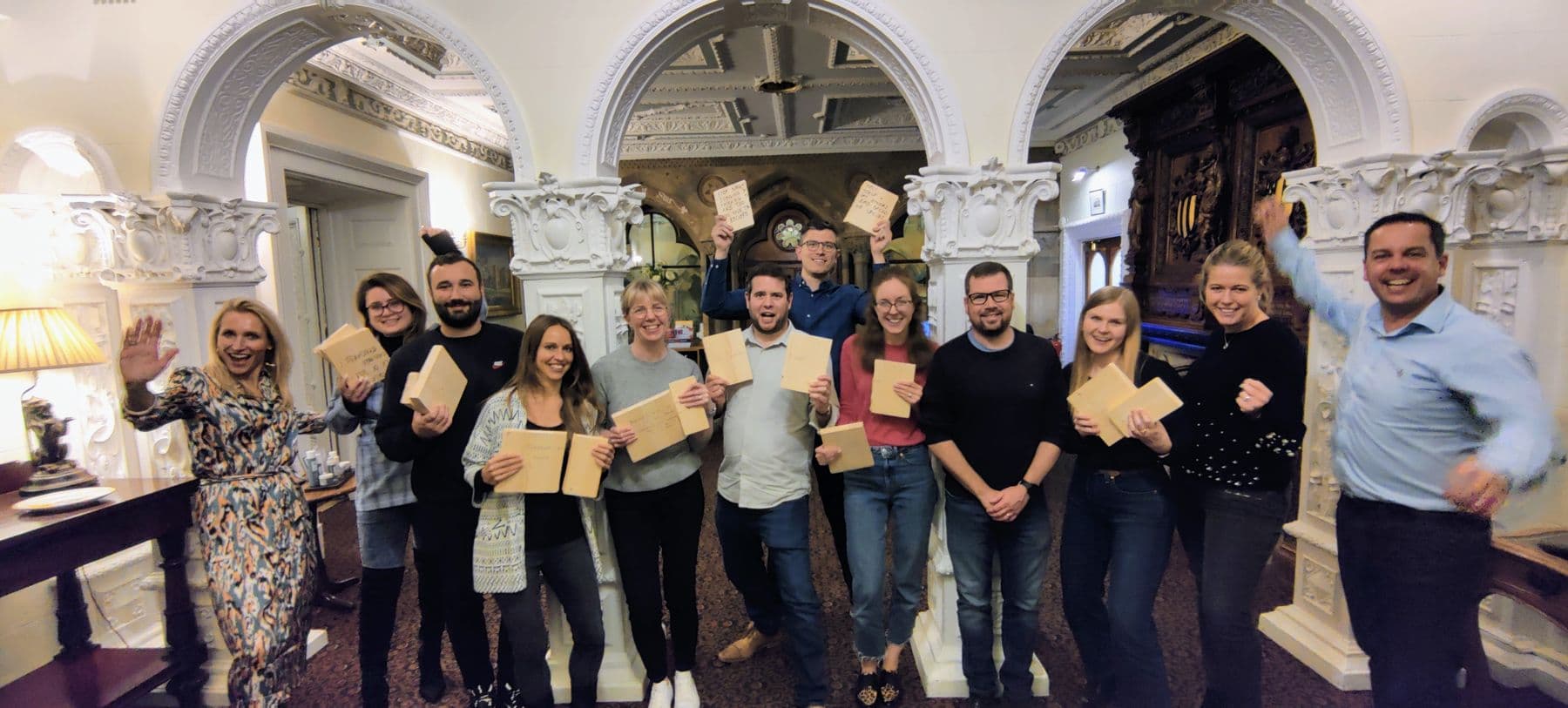 A team holding up their broken boards and celebrating together