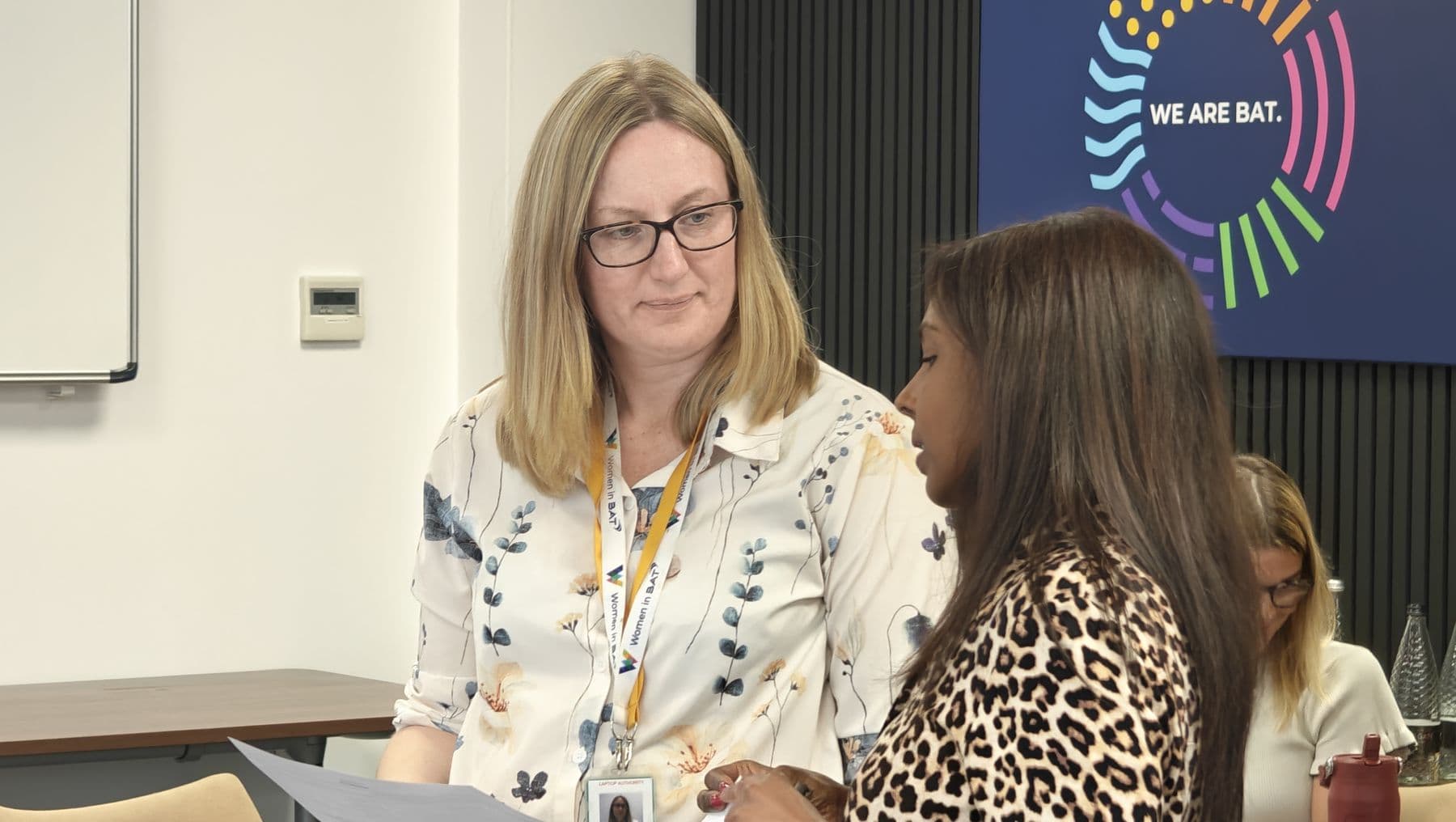Two colleagues in a focused conversation during a session