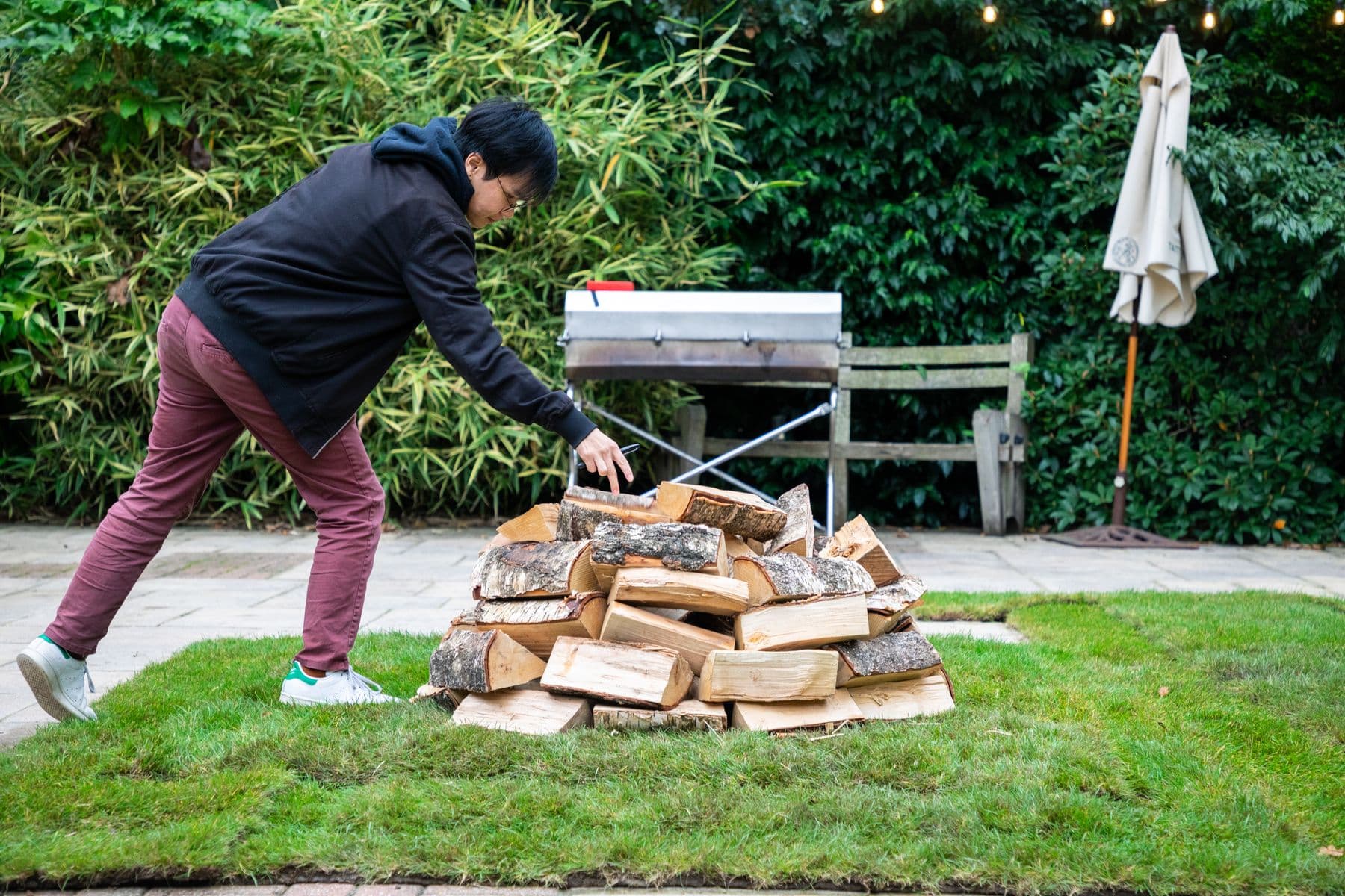 The fire being built on a lawn before a fire walk