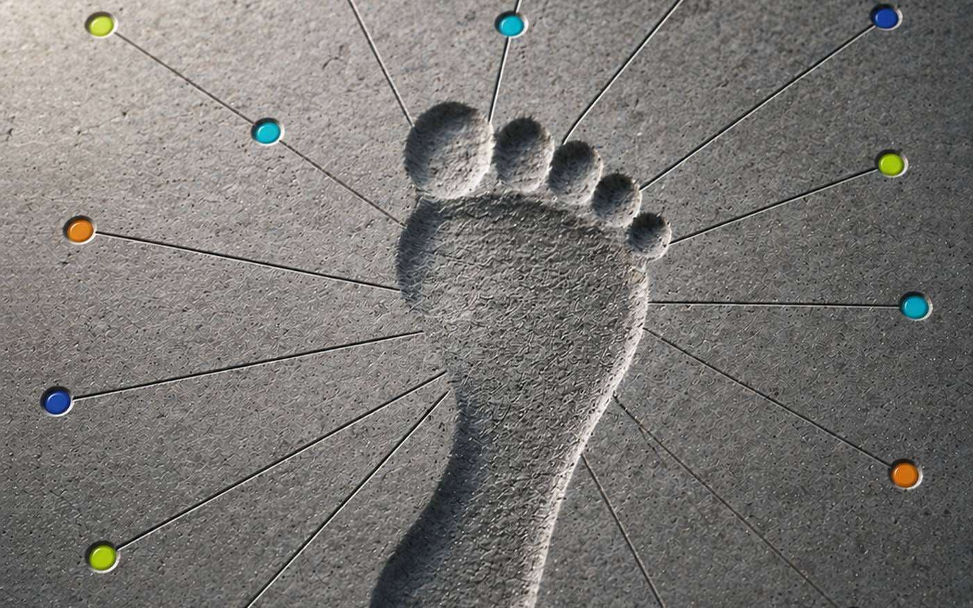 A bare footprint in concrete with coloured pins radiating out on fine lines