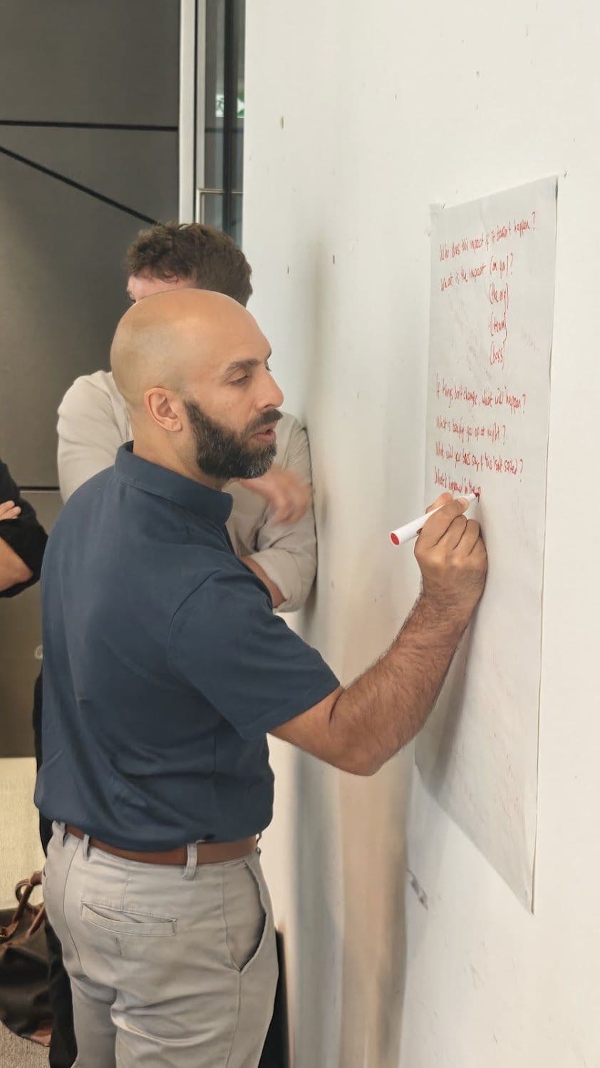 A participant writing on a whiteboard during a sales training day