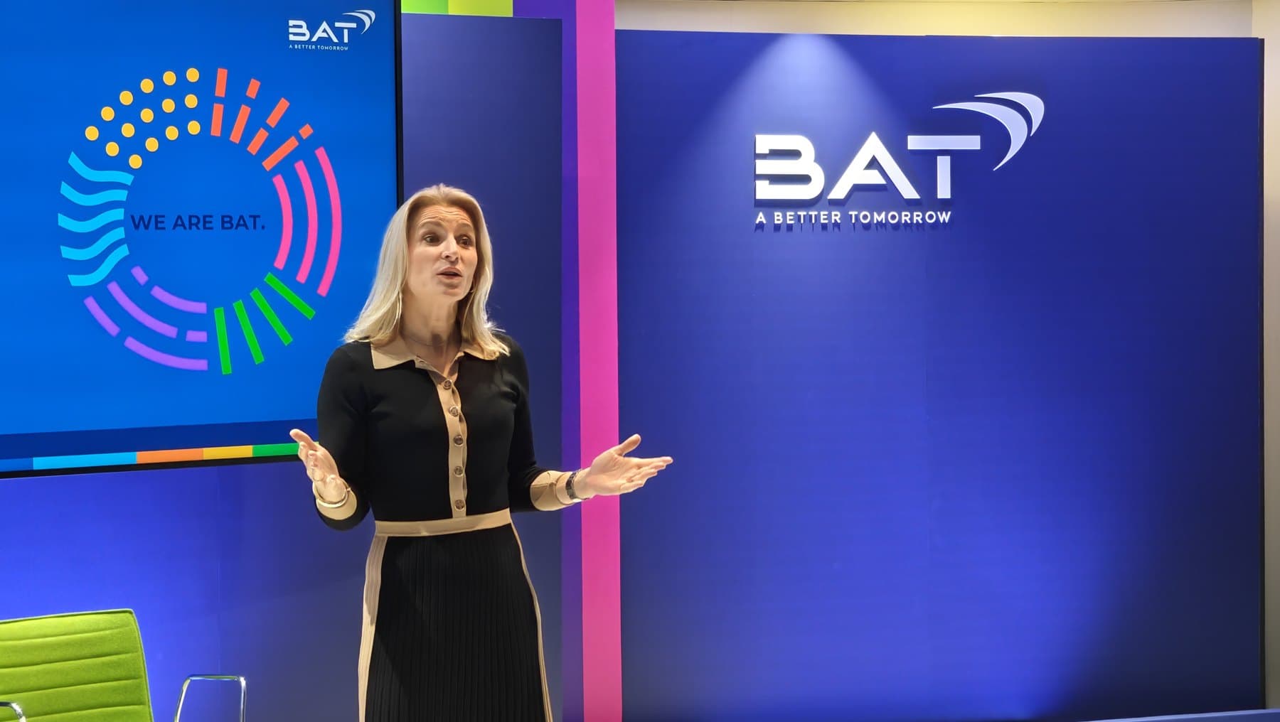 A leader presenting to colleagues at BAT in front of the We Are BAT screen