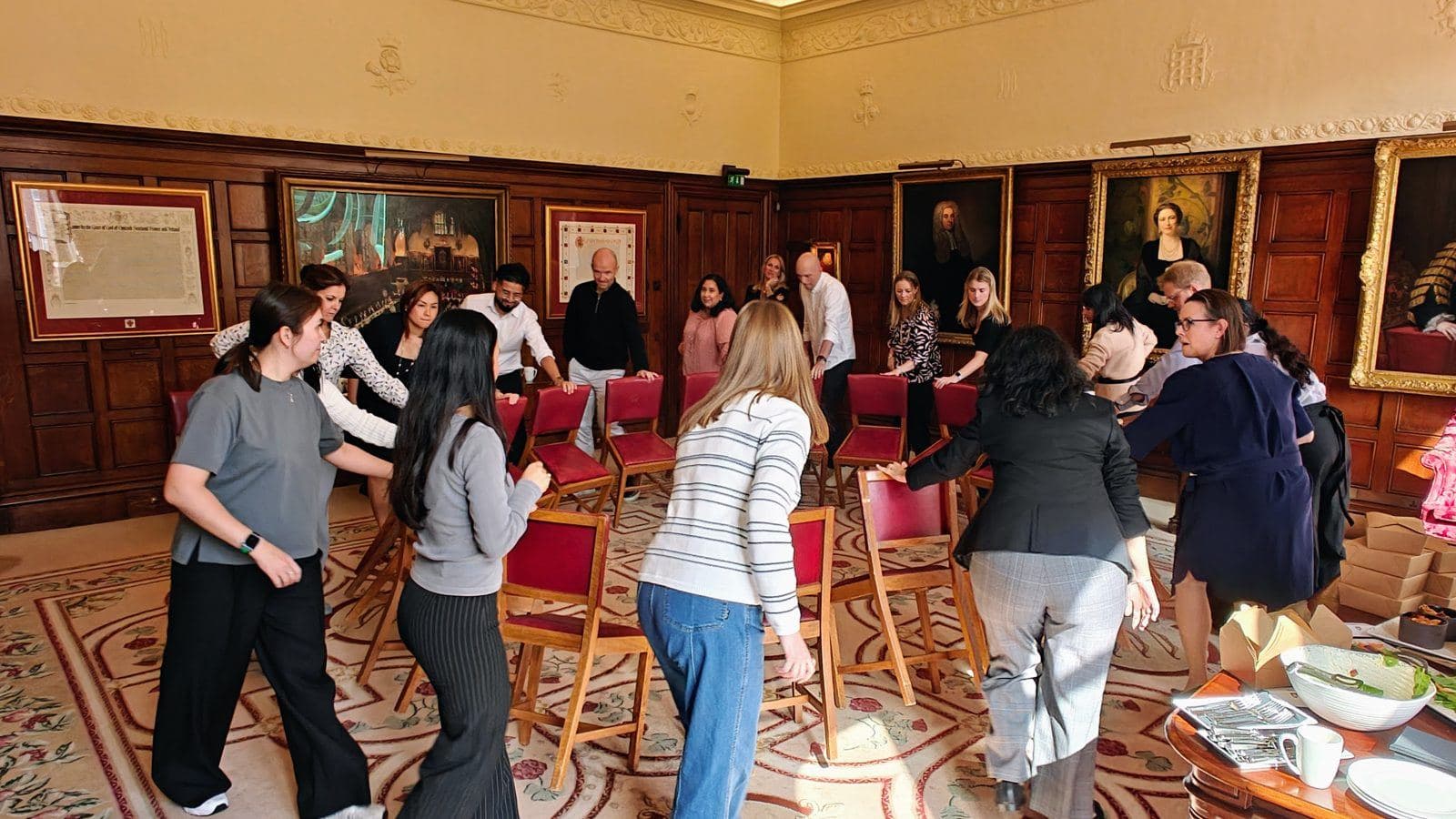 Leaders standing around a circle of chairs during an Inner Leader leadership team day