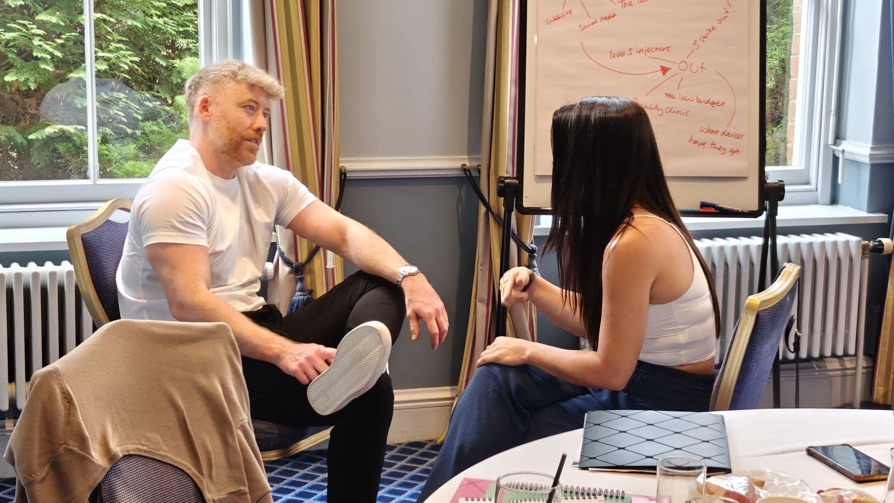 Two participants in a one-to-one conversation during a workshop