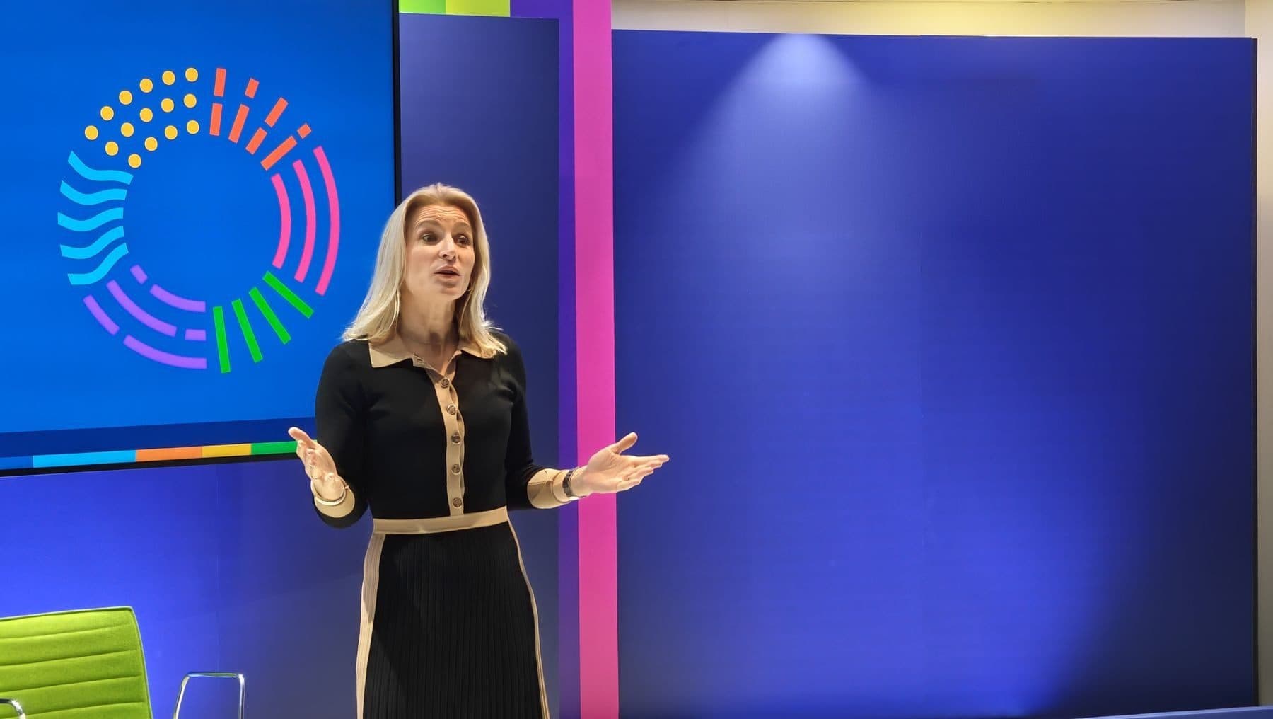A speaker addressing the audience on stage at a company conference