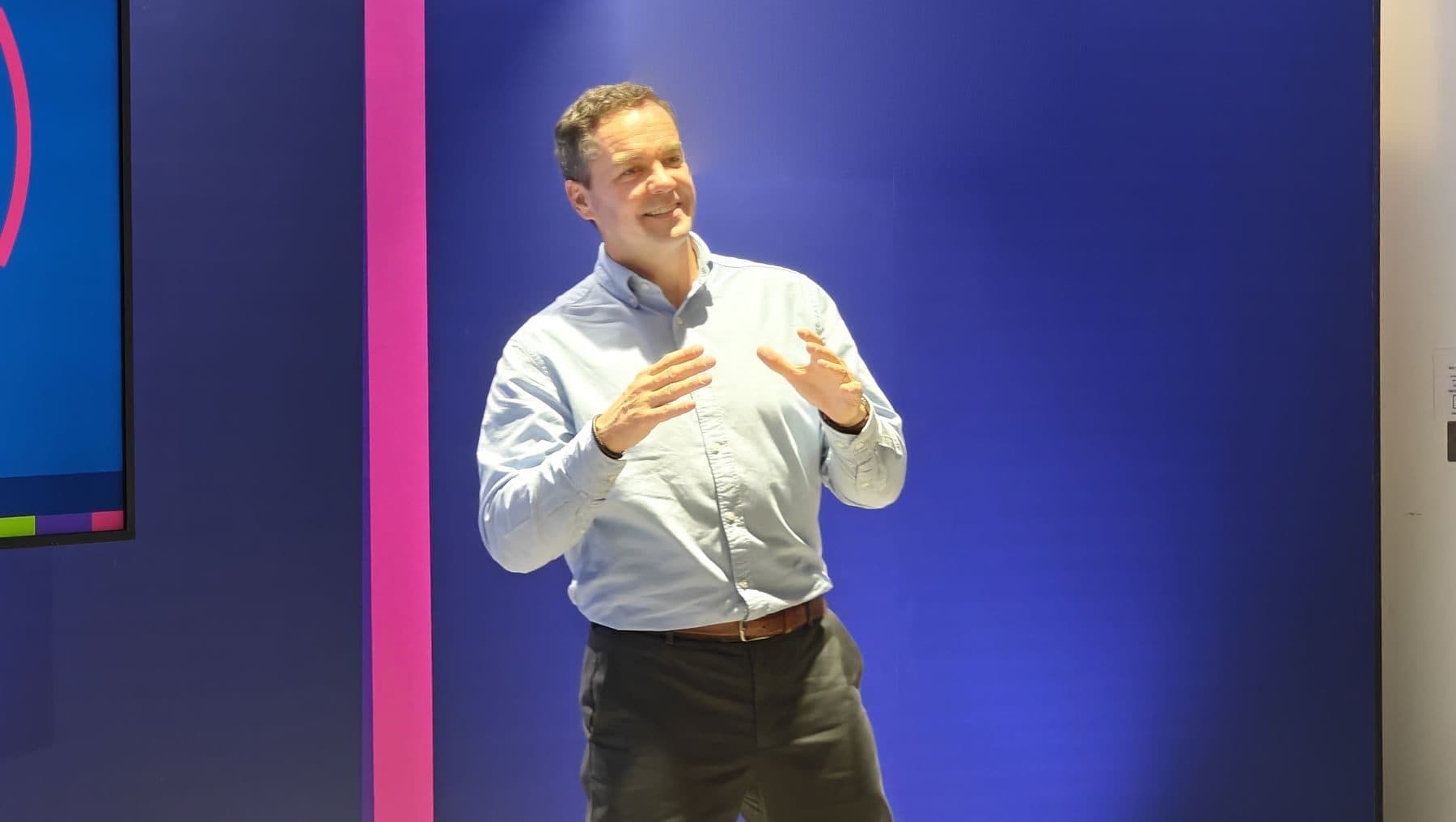 A speaker talking on stage at a company conference
