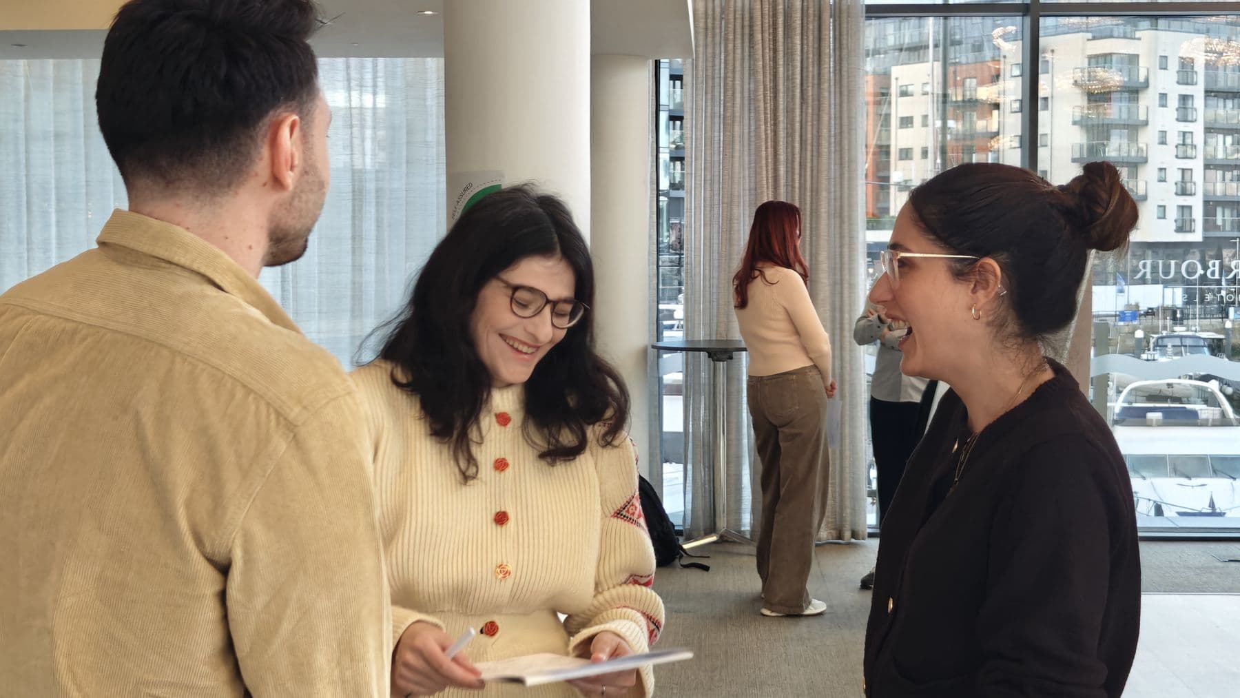 Colleagues smiling in conversation during a practice exercise